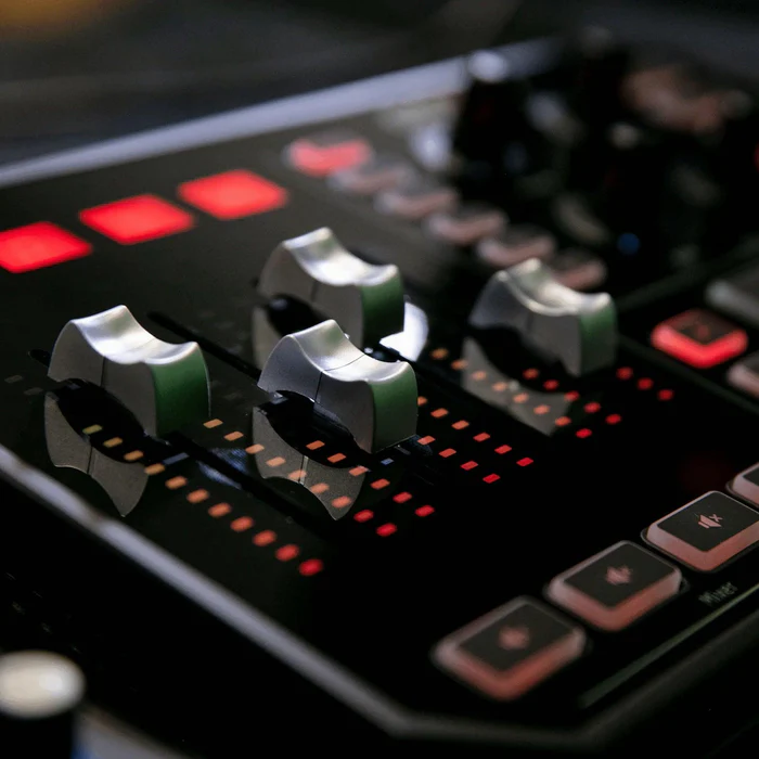Close-up of the GoXLR faders and its red and amber LED meters.