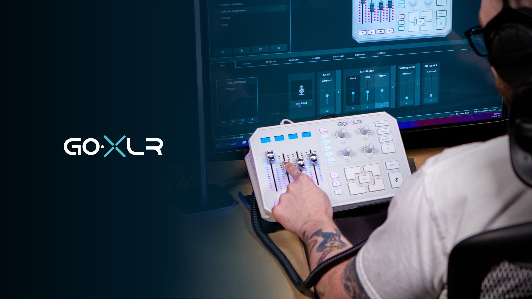 A white GoXLR beside a monitor showing the mixer application, with the routing and mic tabs visible.